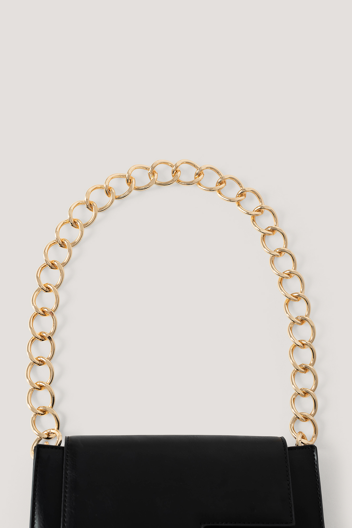 black bag with chunky gold chain